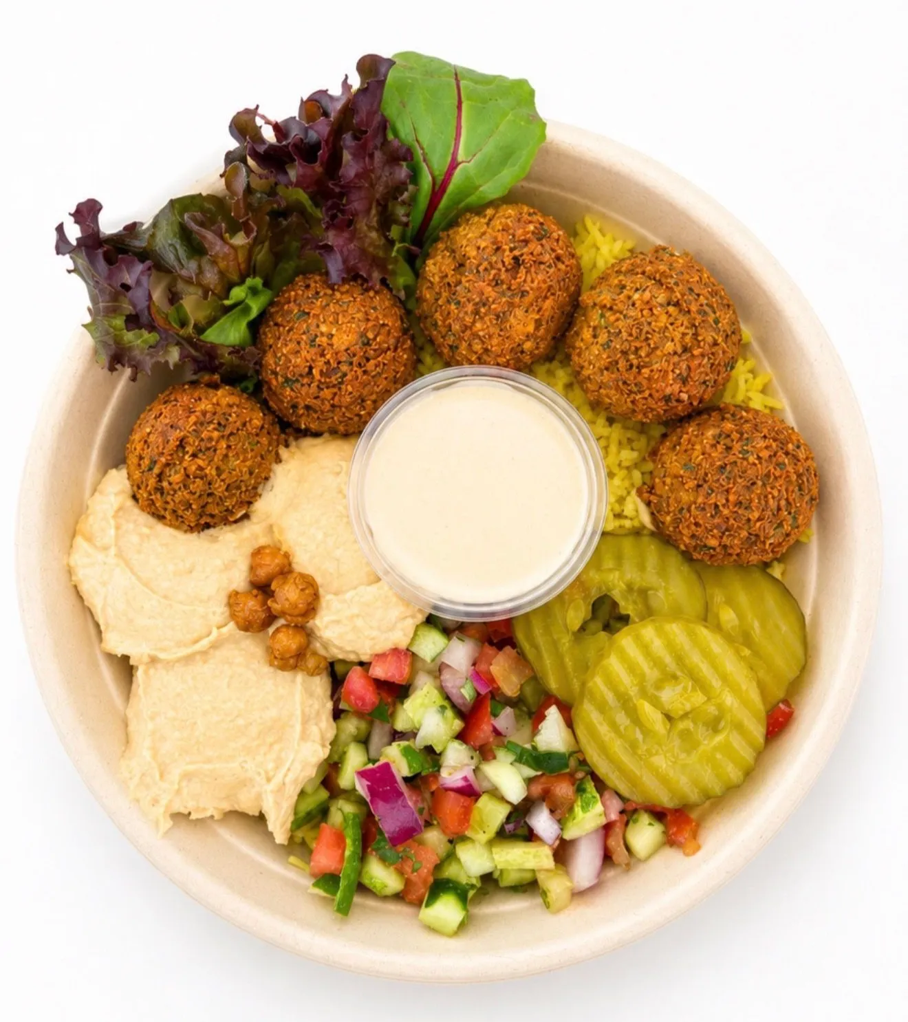 Green Warrior vegan bowl with crispy falafel, hummus, chop salad, pickles and tahini